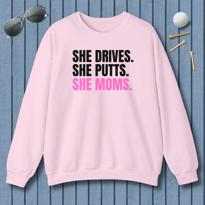 SHE DRIVES. SHE PUTTS. SHE MOMS. - Adult Golf Sweatshirt in Light Pink