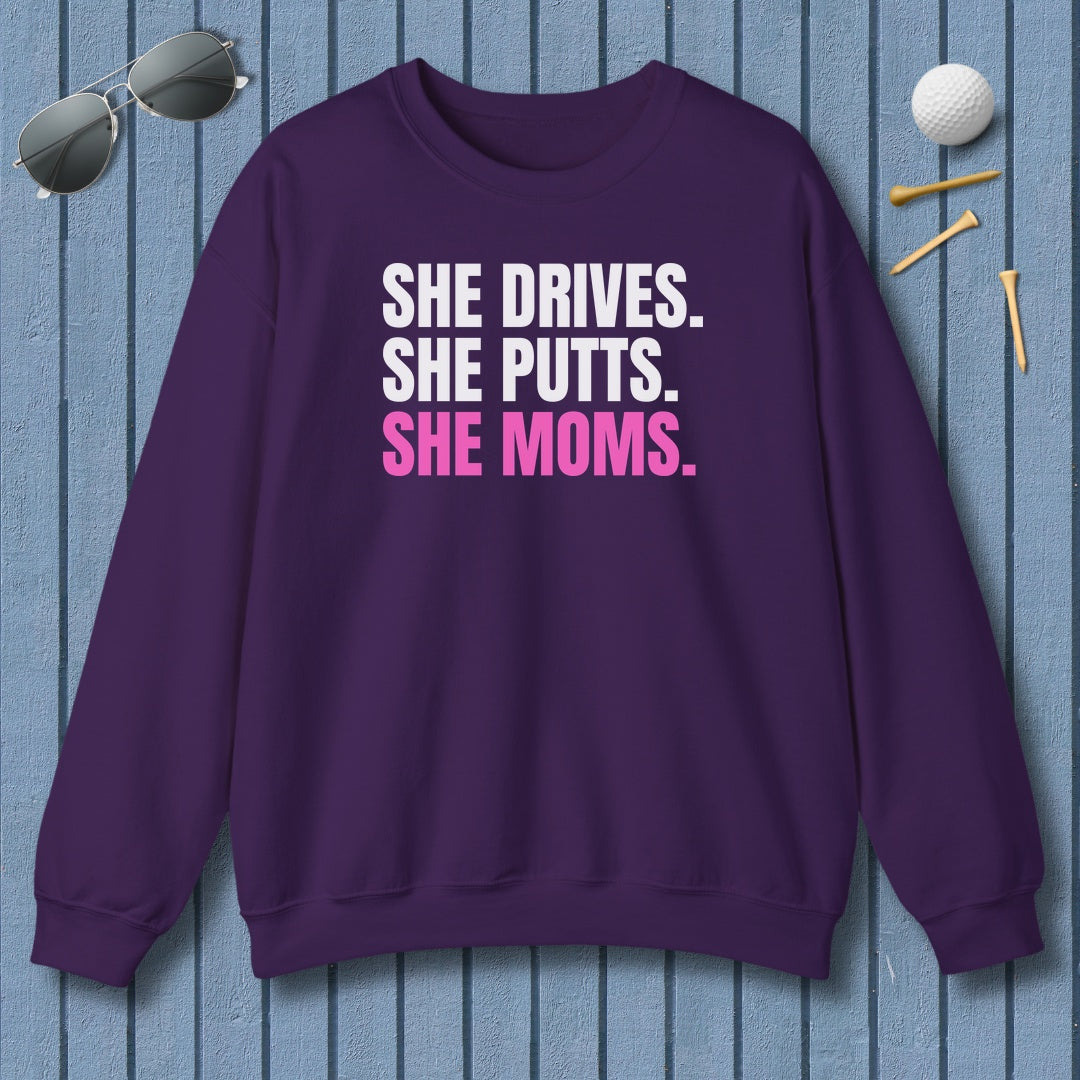 SHE DRIVES. SHE PUTTS. SHE MOMS. - Adult Golf Sweatshirt in Purple