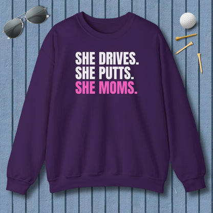 SHE DRIVES. SHE PUTTS. SHE MOMS. - Adult Golf Sweatshirt in Purple